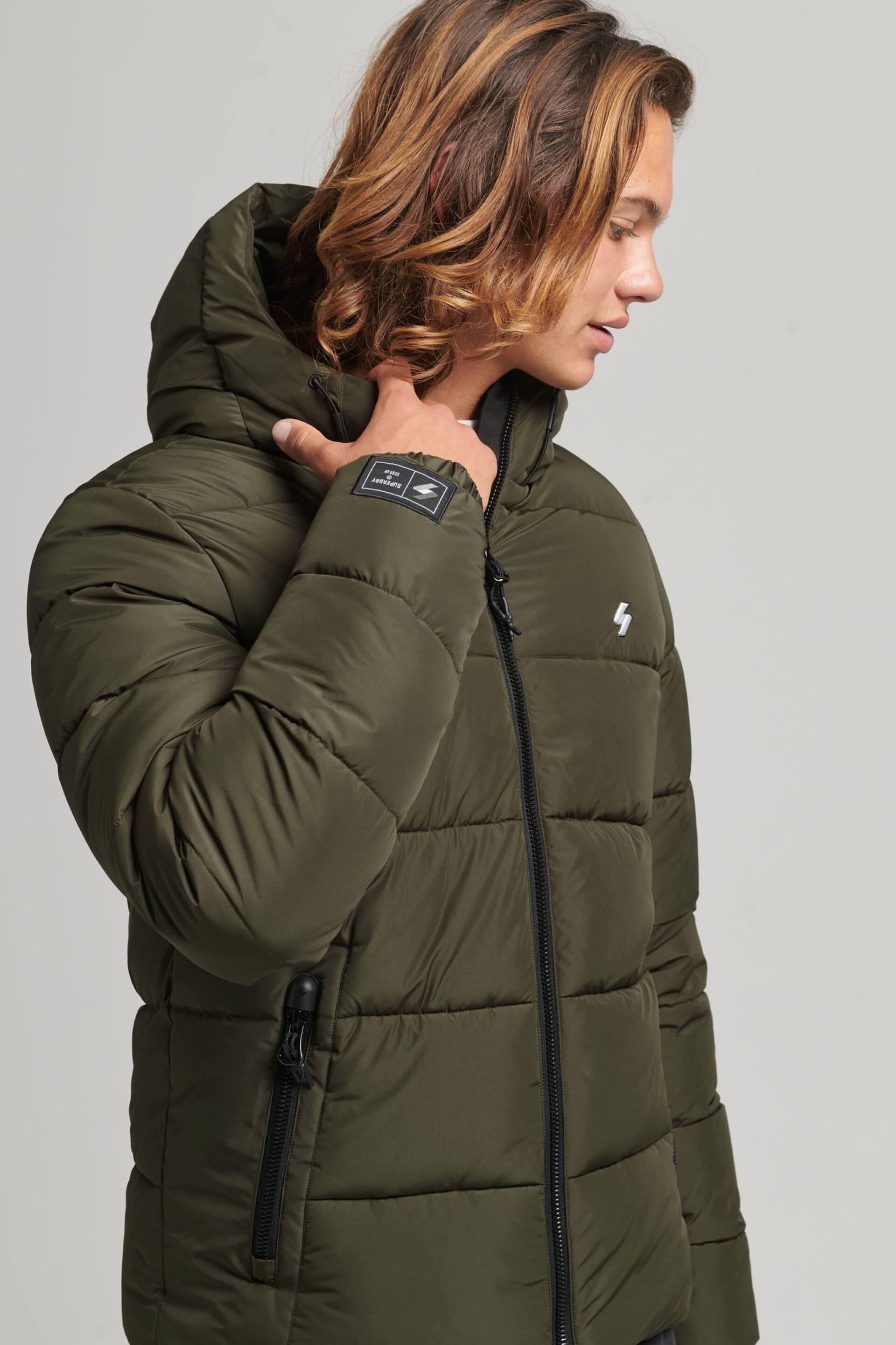 Superdry Dark Moss Hooded Mens Sports Puffer Jacket - Image 1 of 6