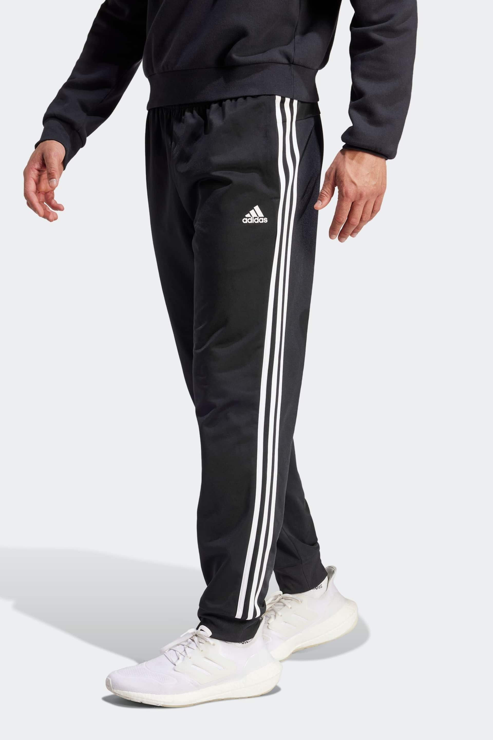 adidas Dark Black Sportswear Essentials Warm Up Tapered 3-Stripes Joggers - Image 1 of 6