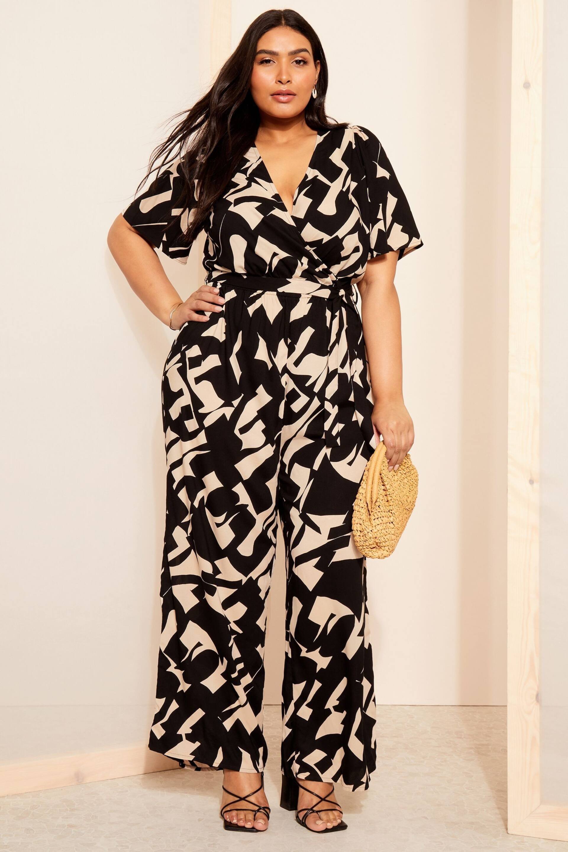 Curves Like These Black/White Flutter Sleeve Wide Leg Jumpsuit - Image 1 of 4