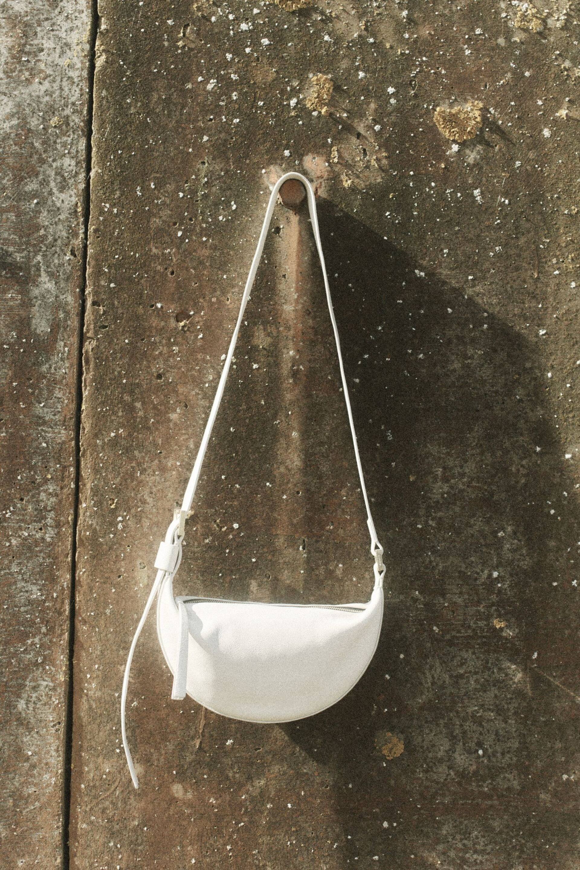 AllSaints White Half Moon Cross-Body Bag - Image 1 of 7